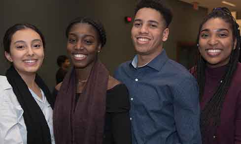 four fairfield university students pose for a photo.
