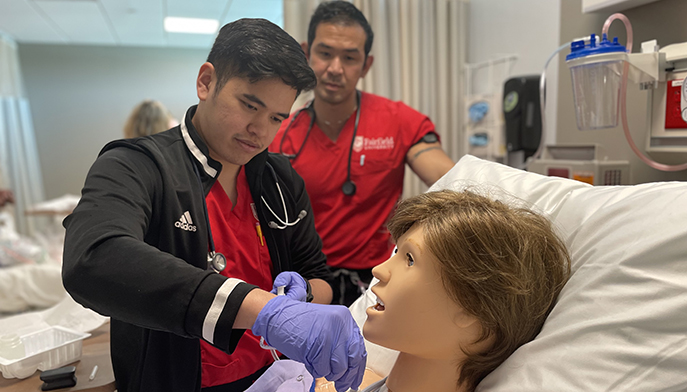 Image of nursing students in hospital like setting.