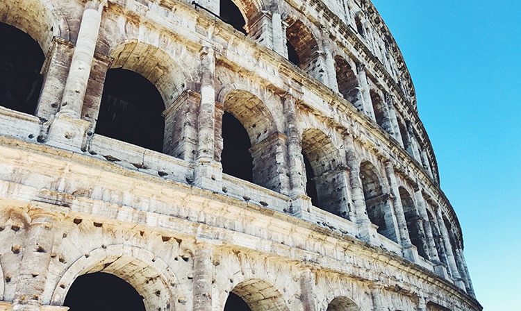 Closeup shot of the exterior of the Roman Colosseum on a clear, sunny day.