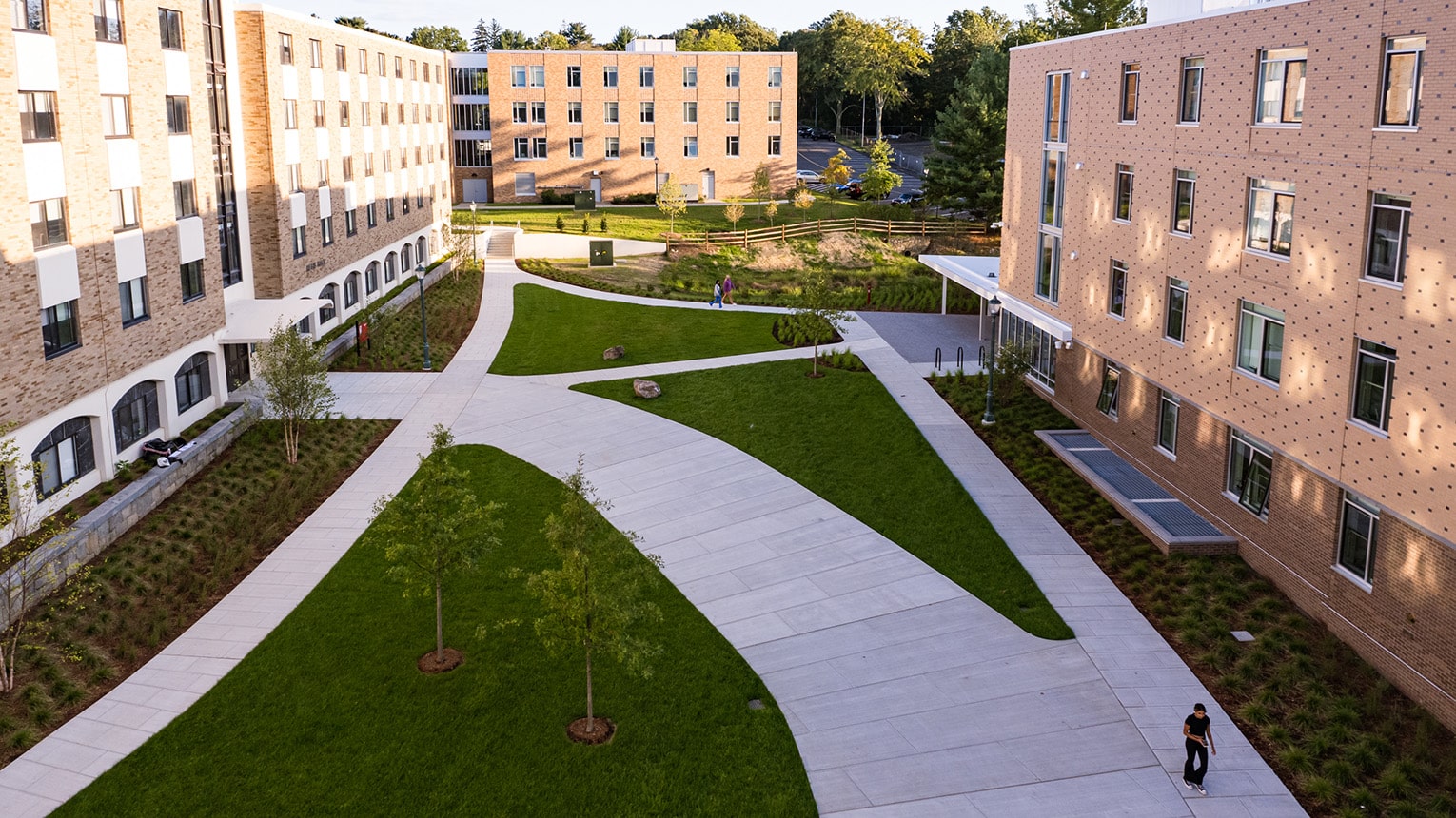 Aerial view of lush campus greenery and intersecting walkways, connecting various buildings.