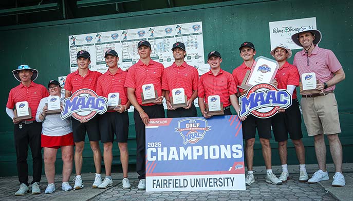 Image of the Fairfield men's golf team stands together, smiling with their trophies after a successful tournament win.