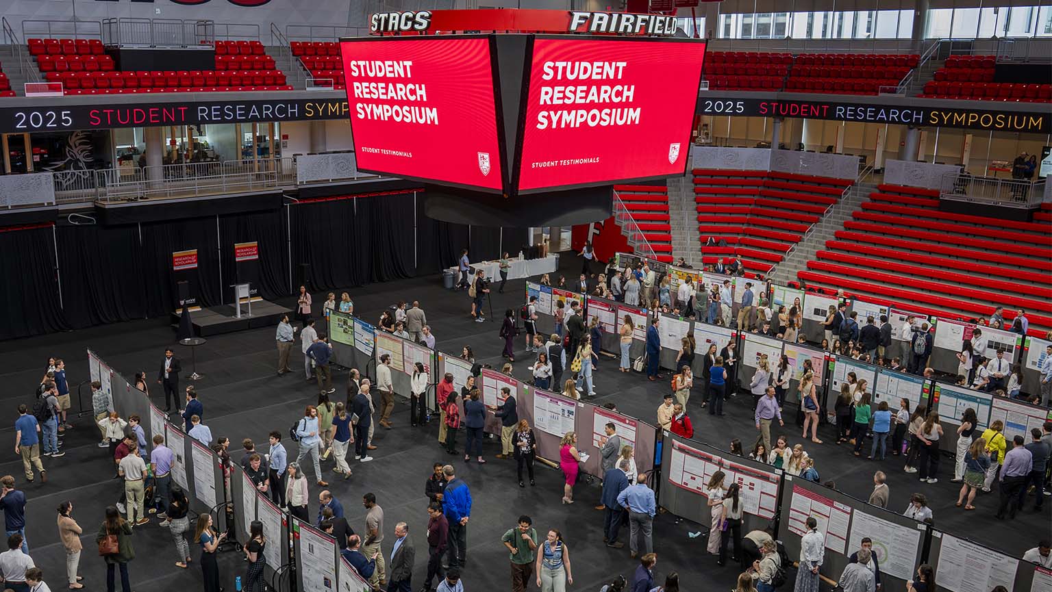 Image of a bustling arena filled with attendees at the Fairfield Student Research Symposium.