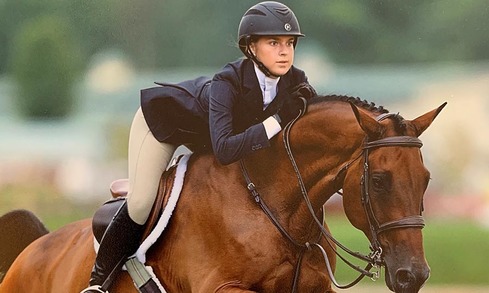 Young woman riding horse.