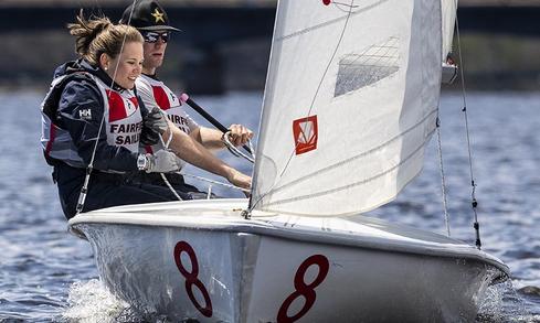 Students sailing on a boat on the water on a bright sunny day.