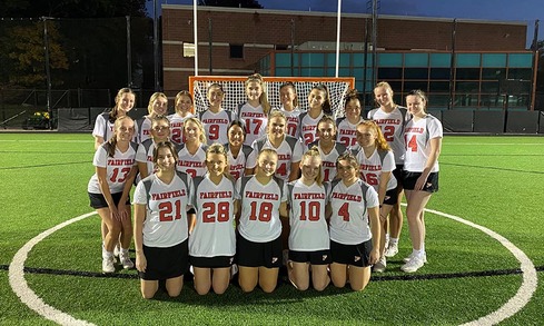 Women's Lacrosse club team on field grouped together for team shot.
